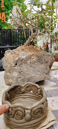 A handcrafted bonsai-style pottery piece in progress